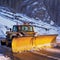 Professional snow removal in winter, a large professional snow blower clears the road of snow and ice,