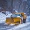 Professional snow removal in winter, a large professional snow blower clears the road of snow and ice,