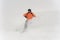 Professional snowboarder in orange sportswear and mask riding do