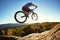 Professional sportsman cyclist jump on trial bike on boulder
