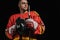 professional sportsman holding hockey stick with helmet and looking away