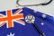 A professional stethoscope perched on a vibrant Australian flag, a symbol of the country's strong healthcare system. Medical