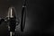 Professional studio microphone and pop filter. Dark gray background. Minimalism. Recording studio, vocals, conversational genre,