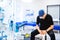 Professional surgeon sitting in operating room with empty table