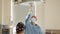Professional Surgeons Turning on Surgery Lights while Bending over Patient. Surgical lamp in the operating room, light