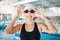 Professional swimming, portrait of happy woman with goggles at pool for exercise, wellness and winner mindset. Water