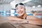 Professional swimming, portrait of happy woman in water at pool for exercise, wellness and winner mindset. Water sport