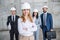 Professional team of architects in helmets standing together