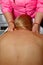 Professional therapeutic back massage. Woman doctor massages girl the athlete in a massage room. body and health care. pain