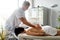 A professional therapist makes a therapeutic massage of the patient& x27;s back. Healing body massage at the medical center.
