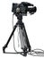 Professional video camera set on a tripod isolated over white