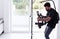 Professional videographer with gimball video slr recording video at home