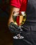 Professional waiter in uniform is serving wine in a glass. Champagne serve for party or celebration in restaurant