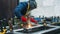 Professional welder in protective uniform with face mask welding with electrode
