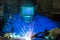 Professional welder welding metal pieces in steel construction