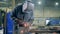 Professional welder working at factory facility. Welding technician in safety wear at work in a factory