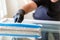 Professional window cleaner using a window cleaning washer sleeve to cleanse a large fold down apartment window