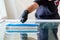 Professional window cleaner using a window cleaning washer sleeve to cleanse a large fold down apartment window