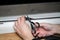 Professional window repair and installation technician, cuts sealing rubber for installation in a pvc window