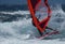 Professional windsurfer riding high waves