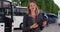 Professional woman in a formal suit talking directly to camera outside