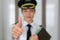 Professional woman pilot portrait giving the thumbs up