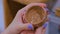 Professional woman potter examining ceramic cup in pottery workshop