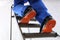 Professional worker climbing up ladder indoors, low angle view