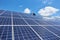 Professional worker installing solar panels on the green metal construction