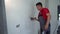 Professional worker man plastering wall with trowel