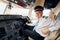 Professional worker. Pilot in formal wear sits in the cockpit and controls airplane