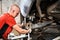 Professional worker, repairman changing car wheel, fixing problem.
