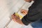 Professional worker using ruler during installation of laminate flooring, closeup