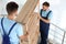 Professional workers carrying wooden  on stairs in office. Moving service