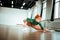 Professional yoga coach in a green turtleneck doing asana for flexibility