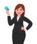 Professional young business woman showing or holding credit/debit/ATM card. Female executive displaying banking card. Modern.