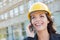 Professional Young Female Contractor Wearing Hard Hat on Site Using Phone