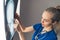 Professionally dressed caucasian female neurologist looking at a skull X-ray and pointing to the area that seems to be