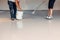 Professionals in the installation of epoxy resin floors apply a non-slip flooring system