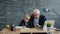 Professor caring grandfather teaching little boy grandson in class talking writing