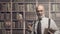 Professor posing in the library with books