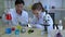Professors are teaching young scientists to do scientific experiments.