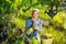 Proffesional winemaker with white wine near basket of grapes