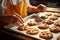 A proficient baker skillfully conveys a tray of warm, mouthwatering cookies