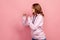 Profile of aggressive teenager girl in hoodie standing with clenched fists and furiously looking left, ready to fight