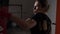 Profile of beautiful attractive blonde woman boxing in a gym to stay fit in slow motion -