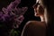 profile of a beautiful blonde woman with a bare shoulder and a bouquet of lilacs