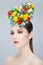 Profile beauty portrait. Beautiful girl with spring colorful flowers. Beauty Face. Creative Make up and Hair Style.