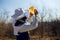 A profile of a beekeeper looking careful a honeycomb to sun light, in the spring time.