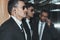profile of bodyguards in sunglasses and businessman